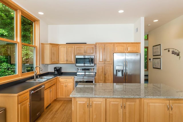 19260 Lakewood Dr, Deerwood Twp, MN 56444 - kitchen featuring appliances with stainless steel finishes, a sink, light wood finished floors, recessed lighting, and dark stone countertops