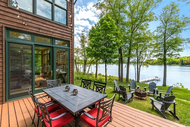 19260 Lakewood Dr, Deerwood Twp, MN 56444 - wooden terrace featuring a water view, an outdoor fire pit, outdoor dining area, and a lawn