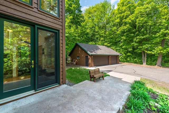 19260 Lakewood Dr, Deerwood Twp, MN 56444 - view of patio / terrace with an outdoor structure and a garage