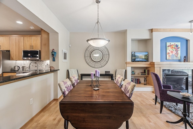 198 Elm St, Saint Paul, MN 55102 - dining room with light wood finished floors, a premium fireplace, and recessed lighting