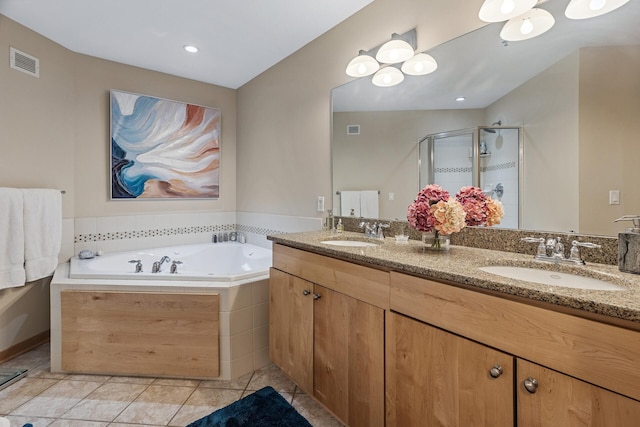 198 Elm St, Saint Paul, MN 55102 - bathroom featuring double vanity, a stall shower, a garden tub, and tile patterned floors
