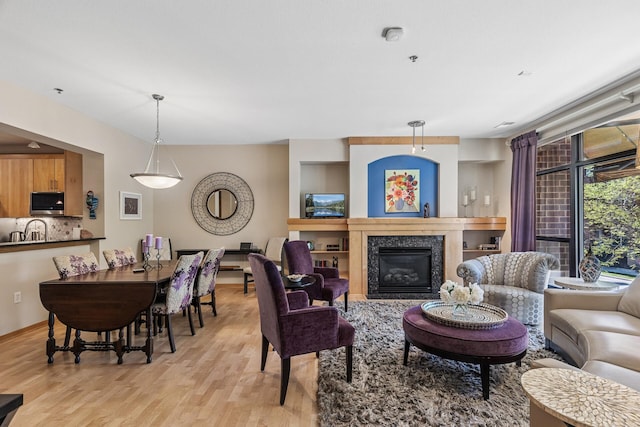 198 Elm St, Saint Paul, MN 55102 - living area with light wood-style floors and a glass covered fireplace