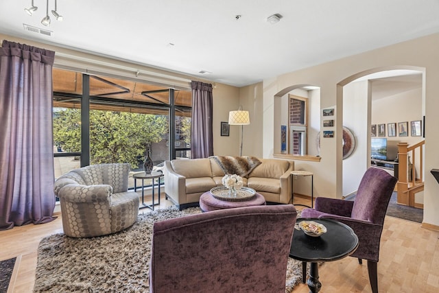 198 Elm St, Saint Paul, MN 55102 - living area with light wood-type flooring, baseboards, and arched walkways