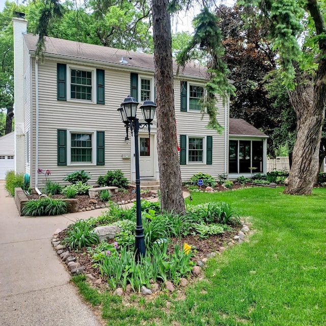 1308 73rd St, Richfield, MN 55423 - colonial-style house with a chimney, a front lawn, and an outdoor structure