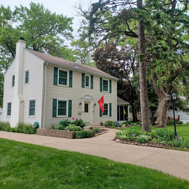 1308 73rd St, Richfield, MN 55423 - colonial-style house featuring a chimney and a front yard