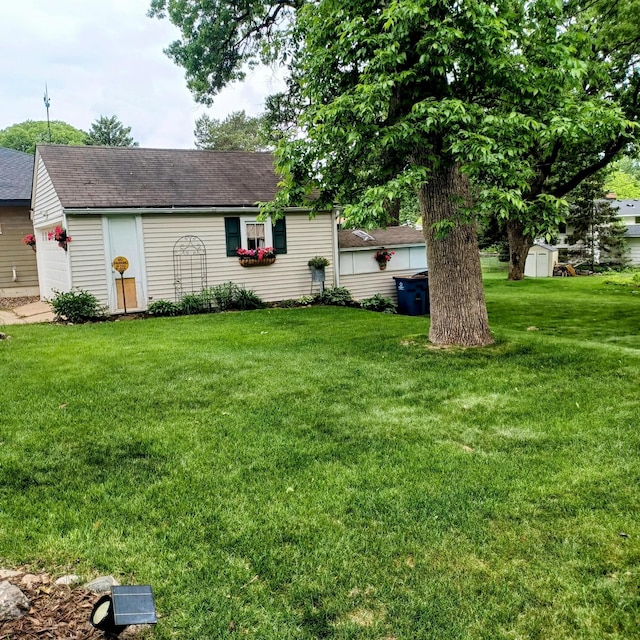 1308 73rd St, Richfield, MN 55423 - ranch-style house with a shingled roof, a front yard, and an outdoor structure