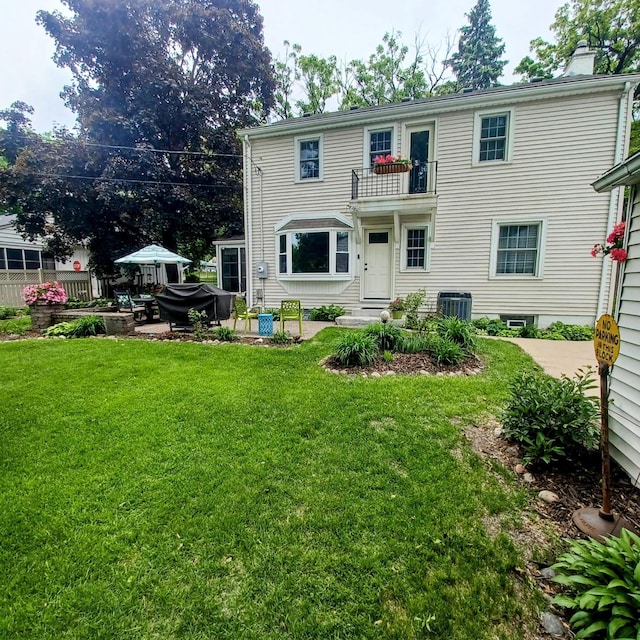 1308 73rd St, Richfield, MN 55423 - back of house featuring a yard, a chimney, a balcony, and central AC unit