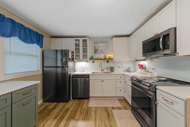 1858 Kennedy Ct, Northfield, MN 55057 - kitchen with appliances with stainless steel finishes, a sink, light wood-style floors, light countertops, and a textured ceiling