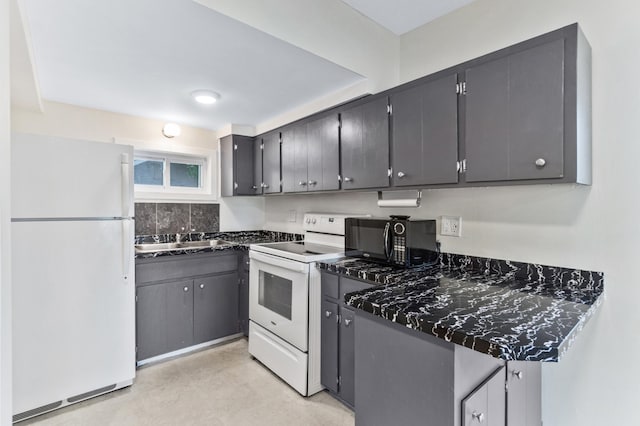 716 15th St NW, Bemidji, MN 56601 - kitchen with white appliances, a sink, and dark countertops