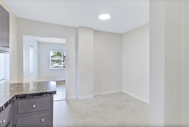 716 15th St NW, Bemidji, MN 56601 - kitchen with dark stone counters and baseboards