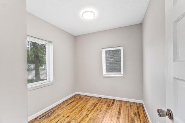 716 15th St NW, Bemidji, MN 56601 - spare room with baseboards and wood-type flooring