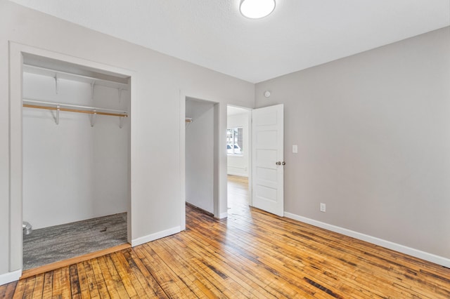 716 15th St NW, Bemidji, MN 56601 - unfurnished bedroom with light wood-type flooring, a closet, and baseboards