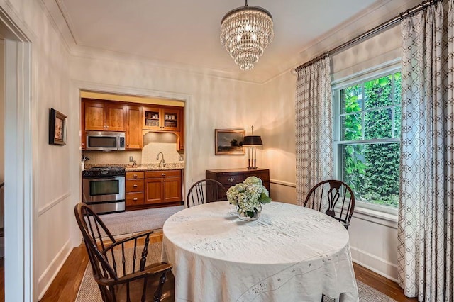2517 Humboldt Ave S Unit 201, Minneapolis, MN 55405 - dining space featuring dark wood-type flooring, baseboards, a chandelier, and crown molding