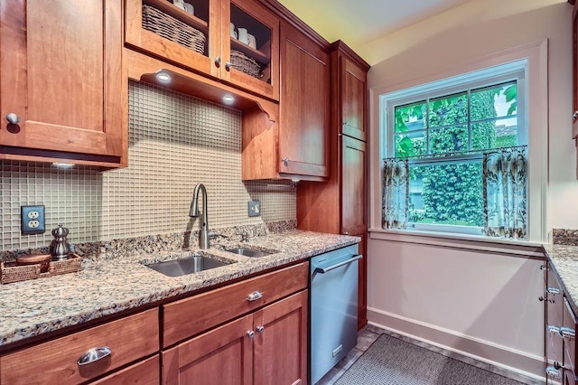 2517 Humboldt Ave S Unit 201, Minneapolis, MN 55405 - kitchen with stainless steel dishwasher, a sink, decorative backsplash, light stone counters, and brown cabinets