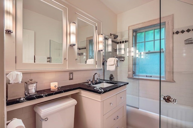 2517 Humboldt Ave S Unit 201, Minneapolis, MN 55405 - bathroom featuring vanity, toilet, tasteful backsplash, and bath / shower combo with glass door