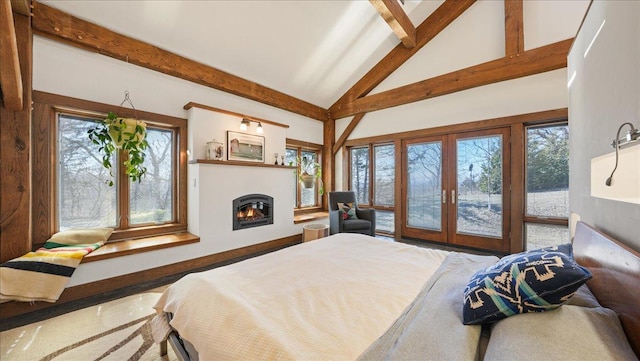 N30732 Square Bluff Rd, Blair, WI 54616 - bedroom with beamed ceiling, french doors, access to exterior, a warm lit fireplace, and high vaulted ceiling