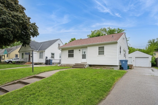 3425 Cleveland St NE, Minneapolis, MN 55418 - view of front of house with an outdoor structure, a garage, a front yard, driveway, and roof with shingles