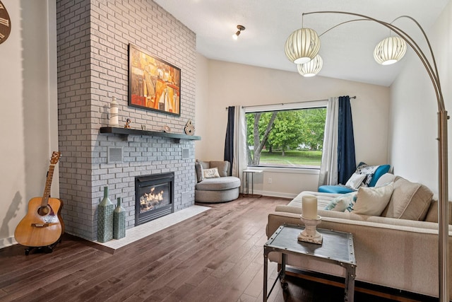 538 Silver Lake Rd NW, New Brighton, MN 55112 - living room with vaulted ceiling, wood finished floors, a brick fireplace, and baseboards