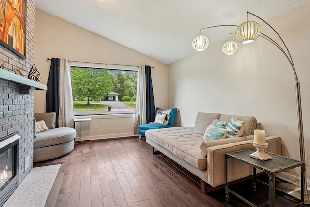 538 Silver Lake Rd NW, New Brighton, MN 55112 - living room with a fireplace, lofted ceiling, hardwood / wood-style flooring, and baseboards