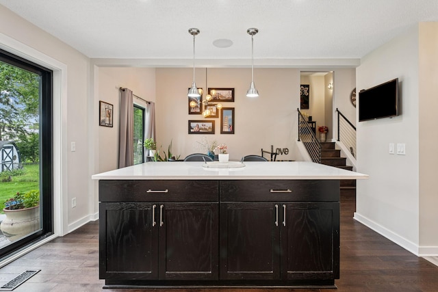 538 Silver Lake Rd NW, New Brighton, MN 55112 - kitchen with dark wood-style flooring, light countertops, baseboards, and healthy amount of natural light