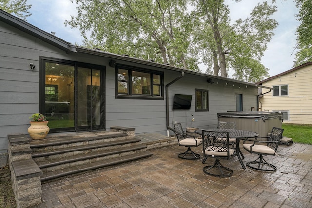 538 Silver Lake Rd NW, New Brighton, MN 55112 - view of patio featuring a hot tub and outdoor dining area