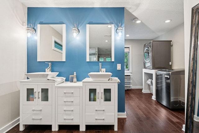 538 Silver Lake Rd NW, New Brighton, MN 55112 - bathroom with estacked washer and dryer, double vanity, baseboards, wood finished floors, and a textured ceiling