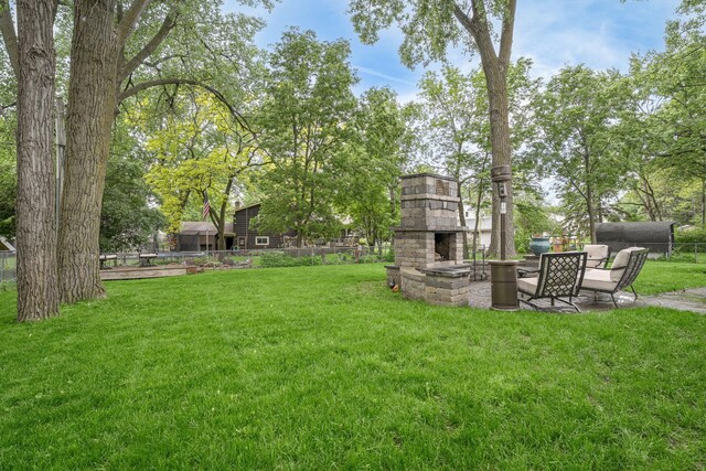 538 Silver Lake Rd NW, New Brighton, MN 55112 - view of yard with an outdoor stone fireplace and a patio