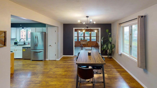 1715 Gateway Dr, Albert Lea, MN 56007 - dining space with a chandelier, dark wood finished floors, healthy amount of natural light, and baseboards