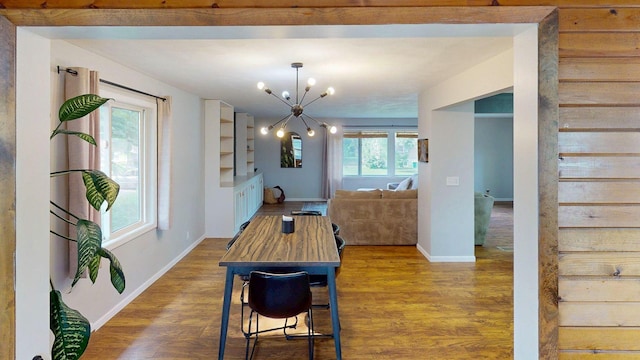 1715 Gateway Dr, Albert Lea, MN 56007 - dining room featuring wood finished floors, baseboards, a chandelier, and healthy amount of natural light
