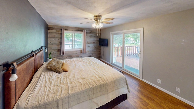 1715 Gateway Dr, Albert Lea, MN 56007 - bedroom with access to outside, multiple windows, wood finished floors, wood walls, and baseboards
