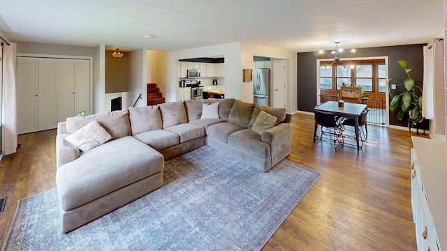1715 Gateway Dr, Albert Lea, MN 56007 - living room featuring a chandelier, stairway, and wood finished floors