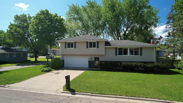 1715 Gateway Dr, Albert Lea, MN 56007 - split level home with concrete driveway, a garage, and a chimney