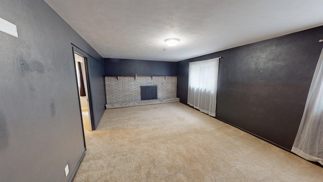 1715 Gateway Dr, Albert Lea, MN 56007 - unfurnished living room featuring a fireplace and carpet