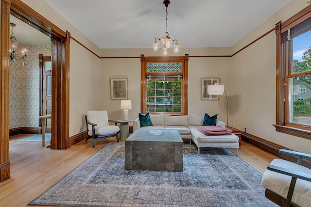 605 7th Ave N, Saint Cloud, MN 56303 - living room featuring a chandelier, hardwood / wood-style flooring, and baseboards