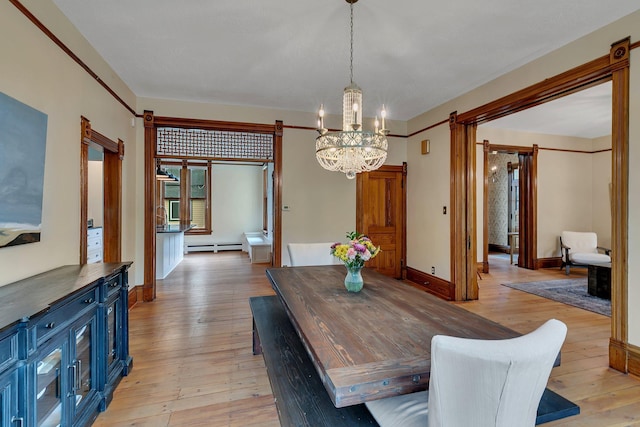 605 7th Ave N, Saint Cloud, MN 56303 - dining room featuring a barn door, a chandelier, light wood finished floors, and a baseboard radiator