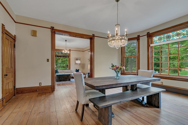 605 7th Ave N, Saint Cloud, MN 56303 - dining space with a chandelier, baseboards, light wood-type flooring, and baseboard heating