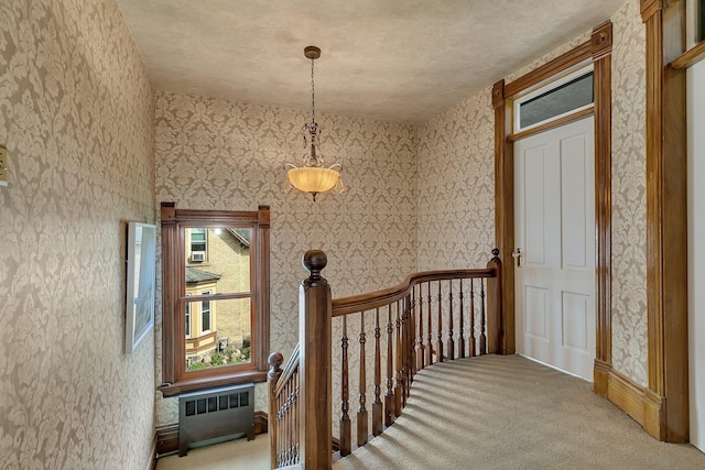 605 7th Ave N, Saint Cloud, MN 56303 - staircase with wallpapered walls, radiator, carpet flooring, and baseboards