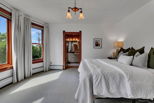 605 7th Ave N, Saint Cloud, MN 56303 - bedroom featuring light colored carpet, a chandelier, baseboard heating, and ensuite bathroom