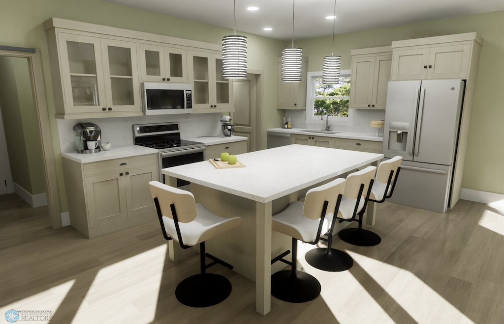 6243 84th Ave S, Horace, ND 58047 - kitchen with white microwave, refrigerator with ice dispenser, a sink, a breakfast bar, and a kitchen island