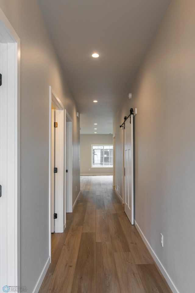 4174 Arthur Dr S, Fargo, ND 58104 - corridor featuring a barn door, wood finished floors, recessed lighting, and baseboards