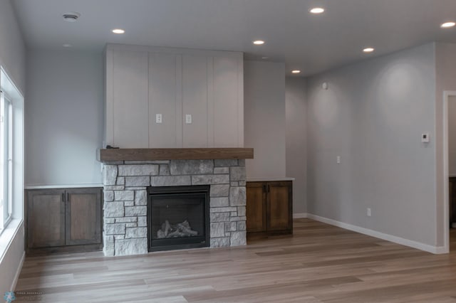 4174 Arthur Dr S, Fargo, ND 58104 - unfurnished living room with light wood finished floors, a fireplace, recessed lighting, and baseboards