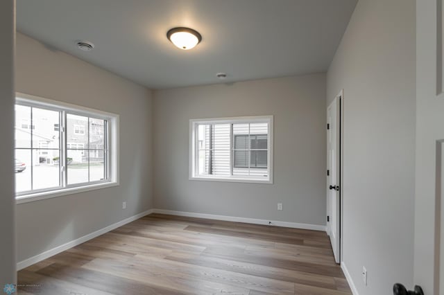 4174 Arthur Dr S, Fargo, ND 58104 - spare room with healthy amount of natural light, light wood-type flooring, and baseboards