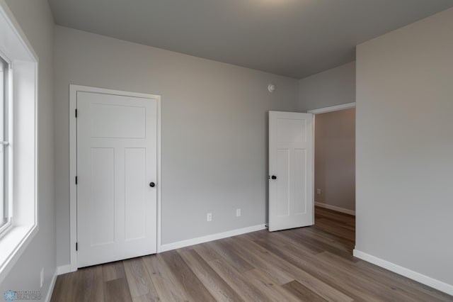 4174 Arthur Dr S, Fargo, ND 58104 - unfurnished bedroom with baseboards and wood finished floors