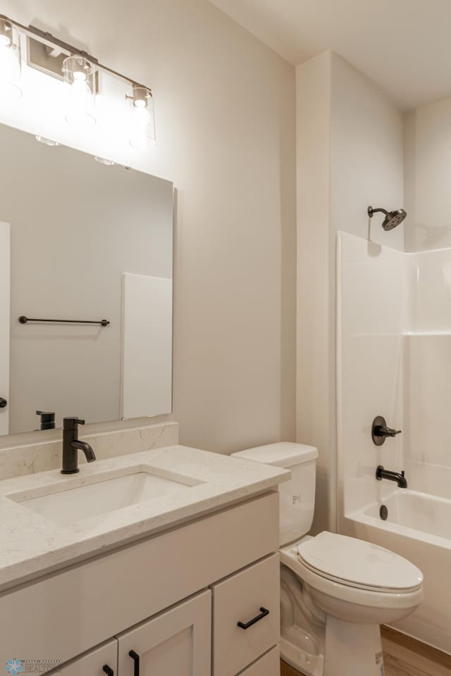 4174 Arthur Dr S, Fargo, ND 58104 - bathroom featuring toilet, vanity, shower / washtub combination, and wood finished floors