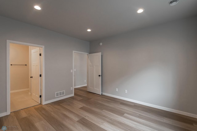 4174 Arthur Dr S, Fargo, ND 58104 - unfurnished bedroom featuring wood finished floors, baseboards, recessed lighting, and connected bathroom