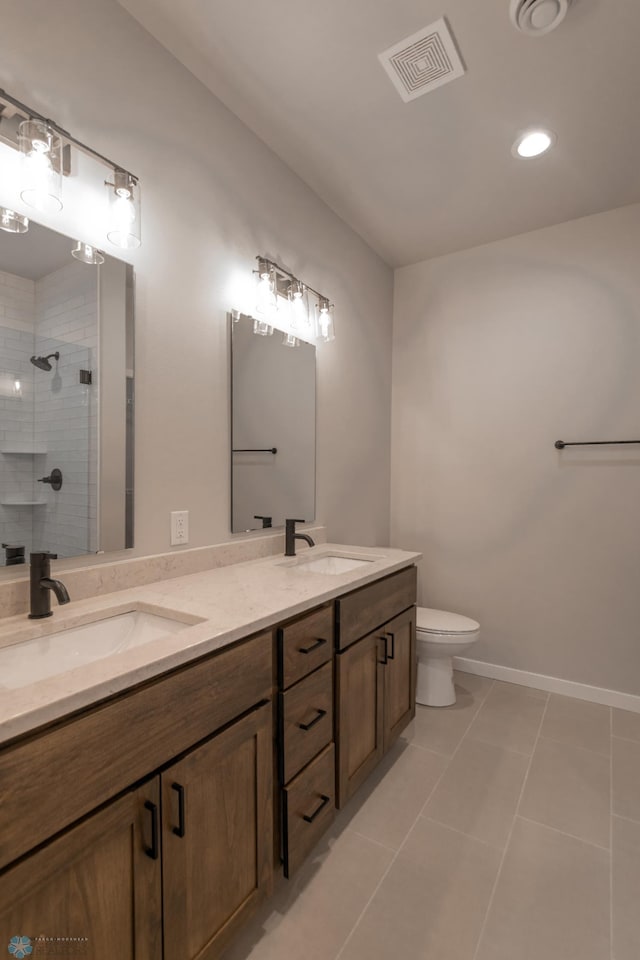 4174 Arthur Dr S, Fargo, ND 58104 - full bathroom featuring double vanity, a shower stall, toilet, recessed lighting, and tile patterned floors
