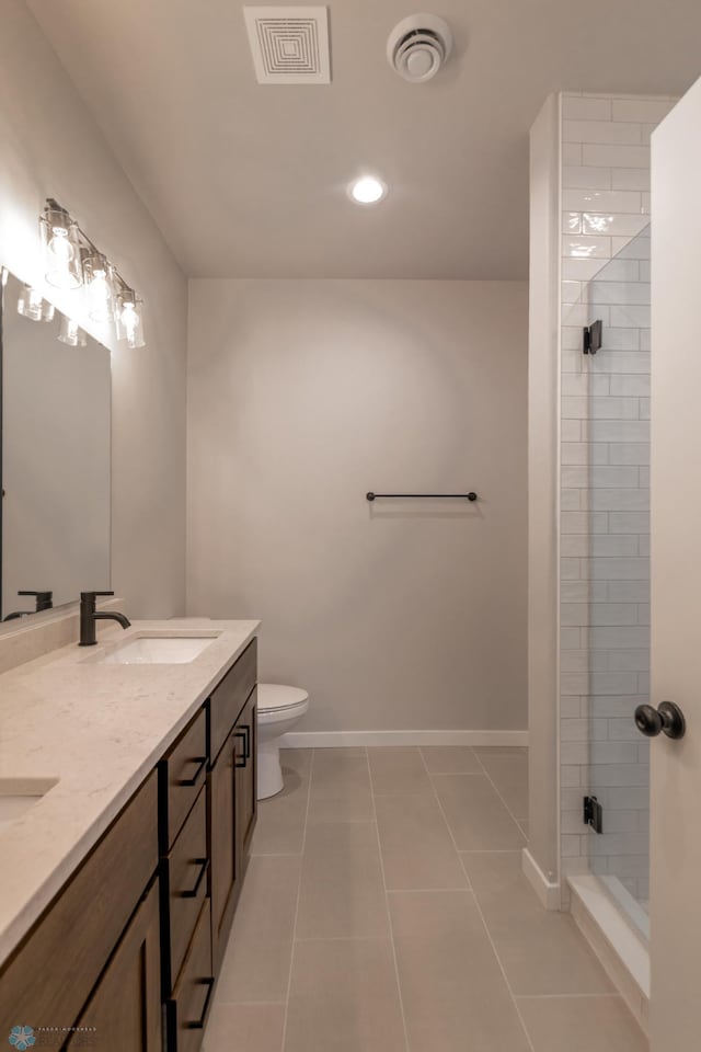 4174 Arthur Dr S, Fargo, ND 58104 - bathroom with double vanity, a shower stall, tile patterned flooring, toilet, and baseboards