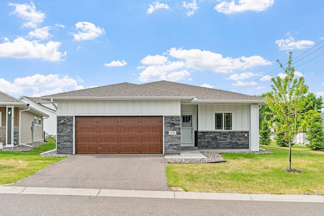 2810 Eastview Ct, Anoka, MN 55303 - view of front of property featuring driveway, an attached garage, a shingled roof, stone siding, and a front lawn
