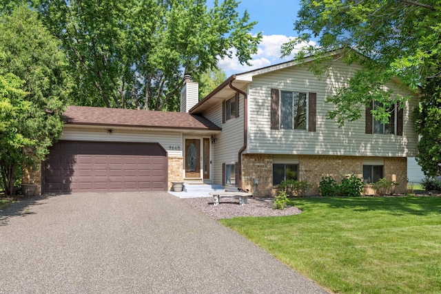 9645 Garrison Way, Eden Prairie, MN 55347 - split level home with asphalt driveway, a garage, a front yard, brick siding, and a chimney