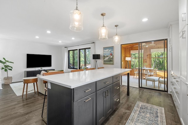 9645 Garrison Way, Eden Prairie, MN 55347 - kitchen featuring a center island, gray cabinetry, recessed lighting, dark wood finished floors, and light countertops